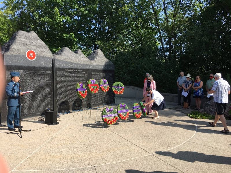 Family members laying wreaths at Memorial Wall