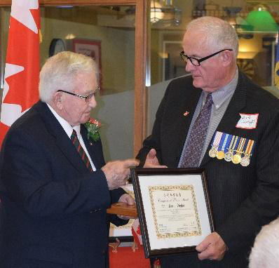 Doug Rees receiving the 
			Chinese Peace Medal from Art Hanger