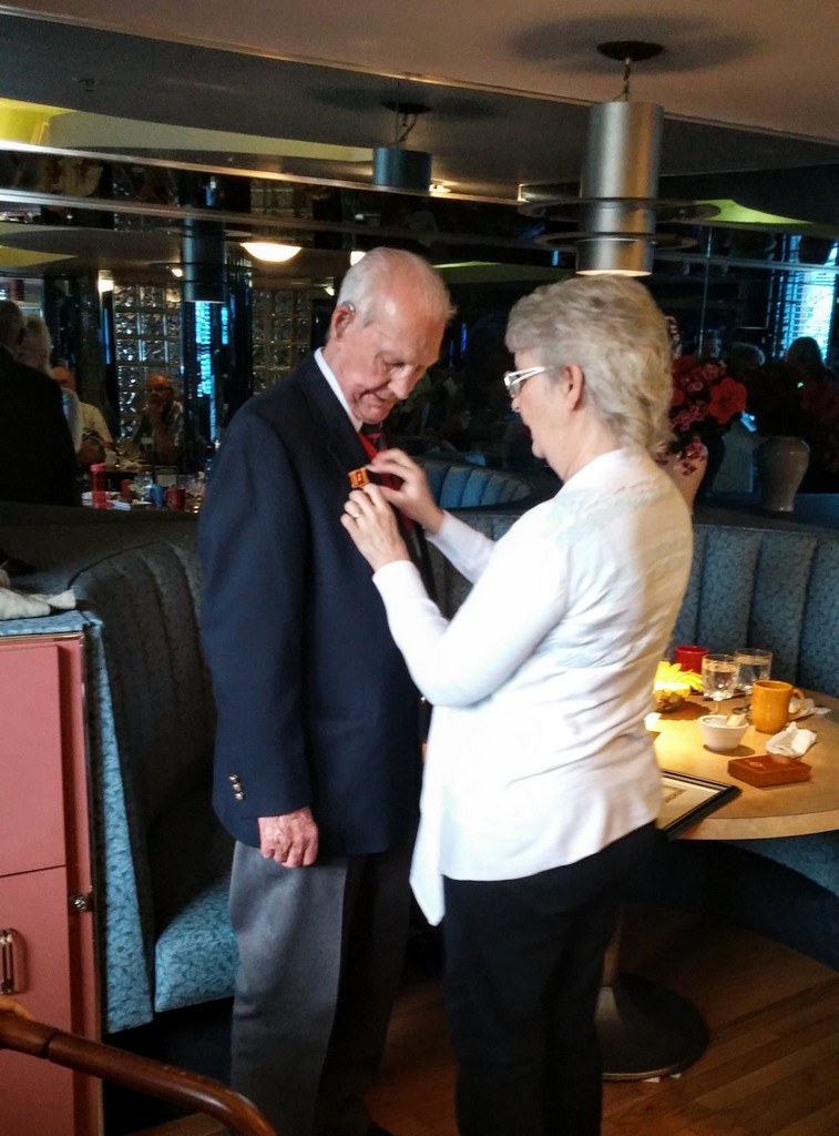 Linda 
	Quesnel (former BC Region Director) pinning the Peace Medal on Gerry 
	Gerrard, Hong Kong Veteran