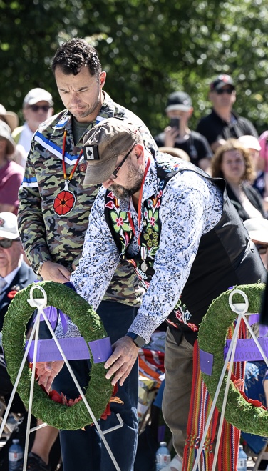 Justin Woodcock and Shawn Nault laying the wreath for Indigenous Veterans. Click for larger view. Image of Justin Woodcock and Shawn Nault laying the wreath for Indigenous Veterans