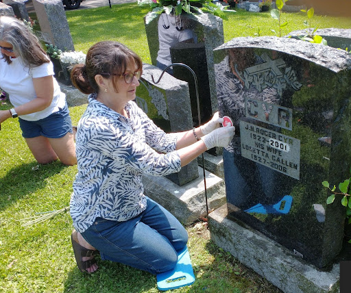 Leisa installed her dad’s (E30726 Roger Cyr) gravestone marker.
(Photo by Derrill Henderson). Click for larger view. Image of Leisa installed her dad’s (E30726 Roger Cyr) gravestone marker. (Photo by Derrill Henderson)