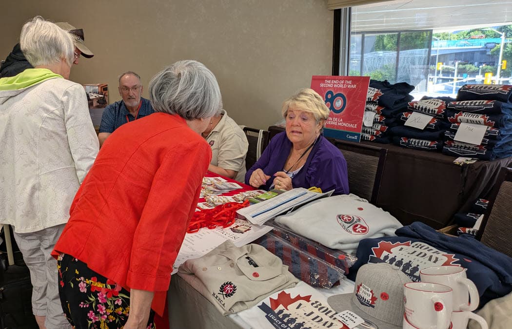 Kathie, in sales-rep mode at the merchandise table (Jim Trick
photo) Click for larger view. Kathie, in sales-rep mode at the merchandise table (Jim Trick photo)