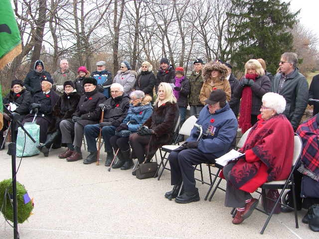 Attendees at the Memorial Wall service, George MacDonell in front row, fourth from the far end