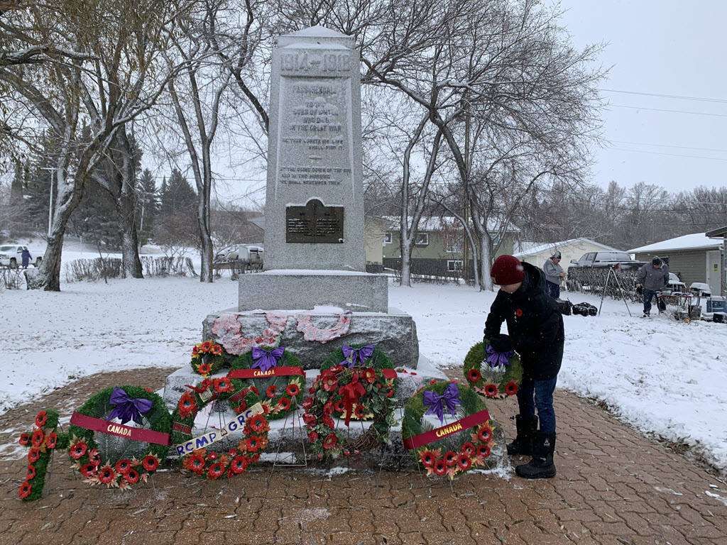 Evan Fulton laying a wreath at Birtle cenotaph